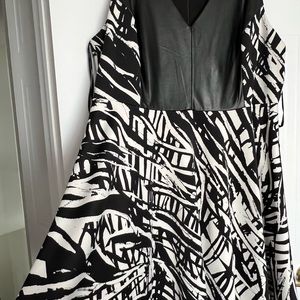 A line black dress with leather appliqué